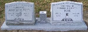 gray granite companion slant headstone with wild roses design and engraved flower vase